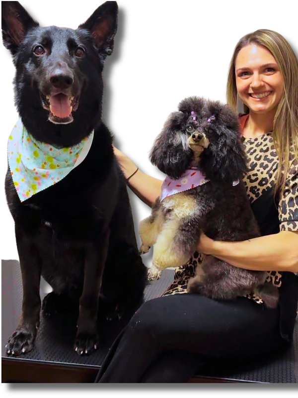 Alissa, nationally certified groomer, with two happy dogs
